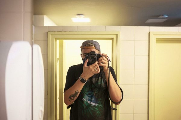 A plumber using a thermal imaging camera or acoustic leak detector to find a hidden leak.